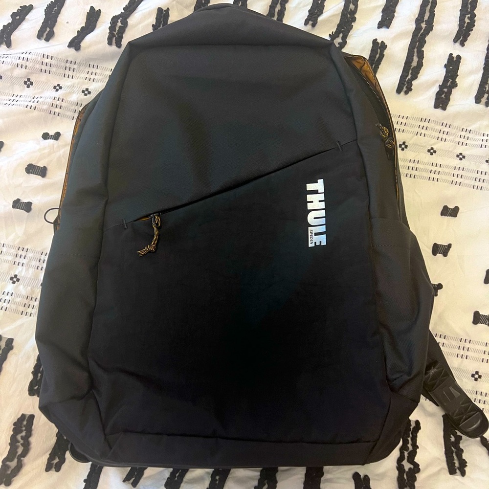 Brand new never been used Thule laptop bag in black. Yellow accents inside